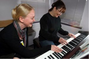 Beth Schuld, left, gives piano lessons to inmate Teresa van Wijk. Schuld says the enthusiasm shown by her Edmonton Institution students is 'like utopia for a music teacher.' Photograph by: Bruce Edwards, edmontonjournal.com